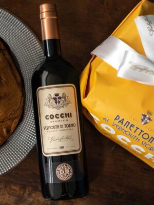 Panettone Cocchi - Foto ambientata con panettone aperto e bottiglia di Vermouth